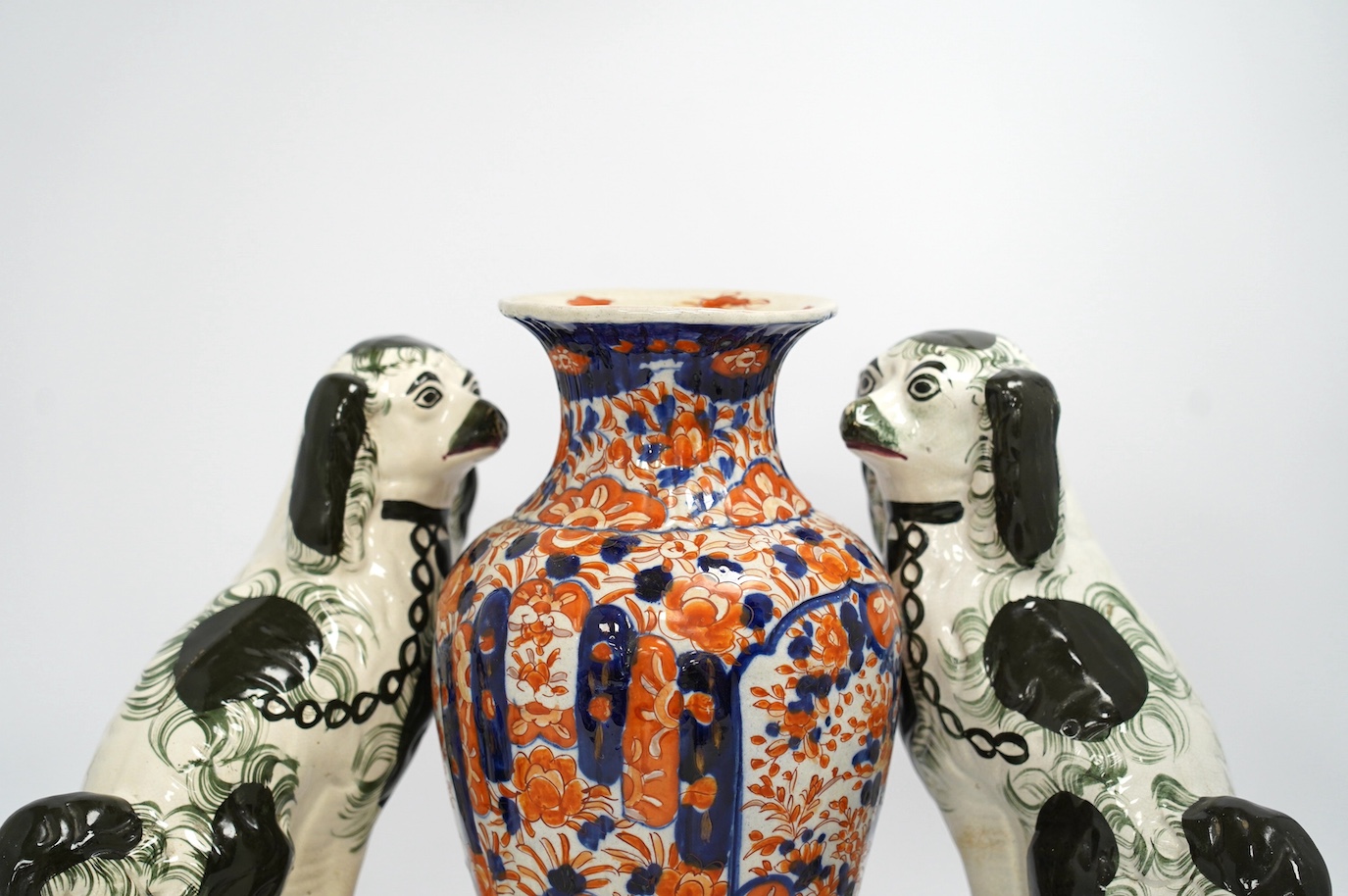 A pair of Victorian comforter spaniels and an Imari vase, vase 31cm high. Condition - fair, vase with a crack to the base